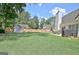 Spacious backyard with lush green lawn, patio, storage shed, and privacy fence offering a perfect outdoor retreat at 155 Westminister Village Blvd, Sharpsburg, GA 30277