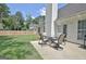 Relax on the backyard patio with a table and chairs in this well-maintained outdoor space at 155 Westminister Village Blvd, Sharpsburg, GA 30277