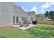 Spacious backyard featuring a patio set with seating, grill, and green lawn for Gathering enjoyment at 155 Westminister Village Blvd, Sharpsburg, GA 30277