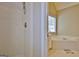 Bathroom shower with white tiles and a peek at the soaking tub and vanity at 155 Westminister Village Blvd, Sharpsburg, GA 30277