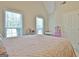 Bright bedroom with two large windows, light walls, and a pink-quilted bedspread at 155 Westminister Village Blvd, Sharpsburg, GA 30277