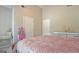 Bedroom featuring light walls, a pink-quilted bedspread, and a charming vanity at 155 Westminister Village Blvd, Sharpsburg, GA 30277