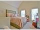 Bright bedroom featuring a plush, pink quilted bedspread and upholstered headboard at 155 Westminister Village Blvd, Sharpsburg, GA 30277