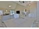 Dining area featuring a chandelier, hardwood floors, and open concept to living room and fireplace at 155 Westminister Village Blvd, Sharpsburg, GA 30277