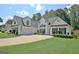 Beautiful two-story home boasts a manicured lawn, attached garage, and lovely curb appeal at 155 Westminister Village Blvd, Sharpsburg, GA 30277