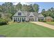 Inviting two-story home featuring a well-maintained lawn, attached garage, and attractive curb appeal at 155 Westminister Village Blvd, Sharpsburg, GA 30277
