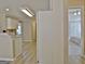Hallway area features light wood floors with an entry to the kitchen and a bedroom at 155 Westminister Village Blvd, Sharpsburg, GA 30277