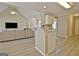 Open-concept kitchen with bar area, white cabinets, hardwood floors, and an open layout at 155 Westminister Village Blvd, Sharpsburg, GA 30277