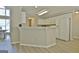 Bright kitchen features white cabinetry, stainless steel appliances, and a bar area for entertaining at 155 Westminister Village Blvd, Sharpsburg, GA 30277