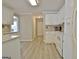 Bright kitchen with white cabinetry, stainless steel appliances, and hardwood floors at 155 Westminister Village Blvd, Sharpsburg, GA 30277