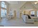 Bright living room with vaulted ceilings, hardwood floors, dining area, and lots of natural light at 155 Westminister Village Blvd, Sharpsburg, GA 30277