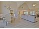 Open concept living room and dining area with modern furnishings, a fireplace, and vinyl floors at 155 Westminister Village Blvd, Sharpsburg, GA 30277