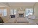Cozy living room featuring a fireplace, comfortable seating, and plenty of natural light at 155 Westminister Village Blvd, Sharpsburg, GA 30277