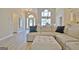 Open-concept living area with a soaring ceiling, chandelier, and large sectional sofa at 155 Westminister Village Blvd, Sharpsburg, GA 30277