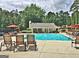 Community pool area with chairs and umbrellas and a small clubhouse for residents at 155 Westminister Village Blvd, Sharpsburg, GA 30277