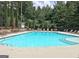 Large swimming pool surrounded by lounge chairs and umbrellas perfect for residents at 155 Westminister Village Blvd, Sharpsburg, GA 30277