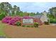 Community welcome sign featuring a seasonal greeting surrounded by flowering bushes at 155 Westminister Village Blvd, Sharpsburg, GA 30277