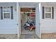 Inside the outdoor storage shed, a riding lawn mower and tools are neatly organized and ready to use at 155 Westminister Village Blvd, Sharpsburg, GA 30277