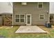 View of the backyard with a concrete patio, tidy lawn, wood fence, and siding at 134 Watercress Ct, Stockbridge, GA 30281