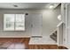 Inviting entryway featuring hardwood floors, stairs, and natural light from the nearby window at 134 Watercress Ct, Stockbridge, GA 30281