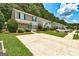 Two-story home with a concrete driveway, healthy lawn, and green shutters on the windows at 134 Watercress Ct, Stockbridge, GA 30281
