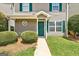 Charming two-story home with a cozy entrance, featuring green shutters and a lush lawn at 134 Watercress Ct, Stockbridge, GA 30281