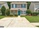 Inviting two-story home with green shutters, a tidy lawn, and a concrete driveway leading to the entrance at 134 Watercress Ct, Stockbridge, GA 30281