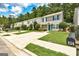 Two-story house with a concrete driveway, healthy lawn, and green shutters on the windows at 134 Watercress Ct, Stockbridge, GA 30281