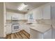 Bright kitchen featuring white cabinets and stainless steel appliances at 134 Watercress Ct, Stockbridge, GA 30281