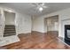 Spacious living room with hardwood floors, fireplace, and stairs to the upper level at 134 Watercress Ct, Stockbridge, GA 30281