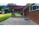 A covered back patio featuring an outdoor seating area and a charming brick exterior at 1527 Patricia Dr, Morrow, GA 30260