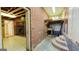 Spacious unfinished basement with brick wall, built-in shelves, and concrete floor at 1527 Patricia Dr, Morrow, GA 30260