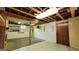 Spacious unfinished basement with exposed ceiling, wood support beam and concrete floor at 1527 Patricia Dr, Morrow, GA 30260
