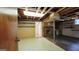 Spacious unfinished basement with exposed ceiling, brick fireplace and concrete floor at 1527 Patricia Dr, Morrow, GA 30260