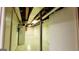 Unfinished basement with exposed ceiling, painted block walls and tile flooring at 1527 Patricia Dr, Morrow, GA 30260