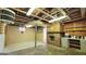 Spacious unfinished basement with exposed ceiling, brick fireplace and concrete floor at 1527 Patricia Dr, Morrow, GA 30260