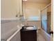 Bathroom features a vanity with dark wood cabinets and tile surround shower with sliding doors at 1527 Patricia Dr, Morrow, GA 30260