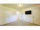 Bedroom features neutral colored walls, carpet, and built-in mounted TV at 1527 Patricia Dr, Morrow, GA 30260