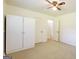 This bedroom has carpeted flooring, a ceiling fan, and a large built-in white wardrobe for plenty of storage at 1527 Patricia Dr, Morrow, GA 30260