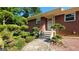 Charming brick home featuring a front entrance with decorative landscaping at 1527 Patricia Dr, Morrow, GA 30260