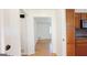 Hallway view with hardwood floors leading to a living room and adjacent kitchen at 1527 Patricia Dr, Morrow, GA 30260