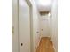 Hallway featuring wood floors and white doors at 1527 Patricia Dr, Morrow, GA 30260