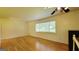 Sunlit living room featuring hardwood floors, ceiling fan, and large window at 1527 Patricia Dr, Morrow, GA 30260