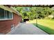 An outdoor patio, brick exterior, and a well-manicured lawn create an inviting space for relaxing at 1527 Patricia Dr, Morrow, GA 30260
