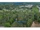 Expansive aerial view of the property, showcasing its wooded acreage and location near downtown Covington at 6111 Old Monticello Se St, Covington, GA 30014