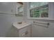 Small bathroom with white tiled walls and a window above the sink at 6111 Old Monticello Se St, Covington, GA 30014
