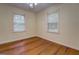 This cozy bedroom has natural light from the two windows and hardwood floors at 6111 Old Monticello Se St, Covington, GA 30014