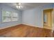 This bedroom has natural light from the large window and light blue paint at 6111 Old Monticello Se St, Covington, GA 30014