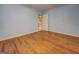 The bedroom has light blue walls and hardwood floors at 6111 Old Monticello Se St, Covington, GA 30014