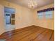 Dining area with hardwood floors, chandelier lighting, and views into the kitchen at 6111 Old Monticello Se St, Covington, GA 30014